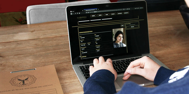 photo of people looking at a computer screen displaying surveillance footage for a murder game at home